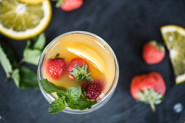 top view of fresh refreshing summer drink with mint and fruits on slate board 