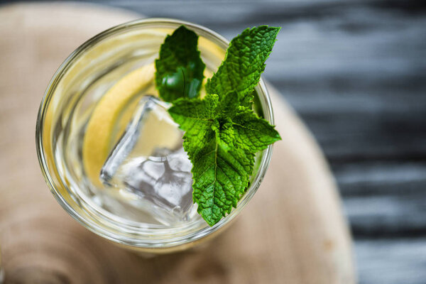 top view of cold fresh summer cocktail with mint and ice cubes in glass 