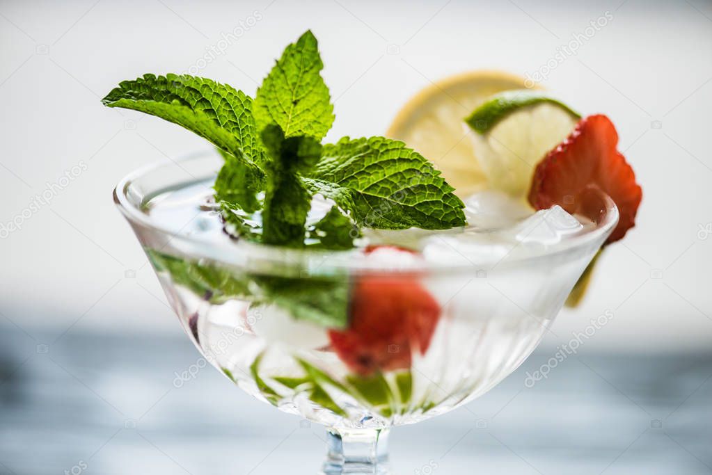 close-up view of fresh cold strawberry mojito cocktail in glass