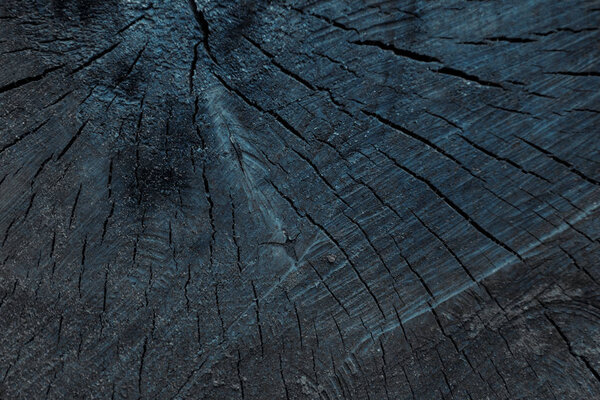 close-up view of dark grey cracked wooden textured background 