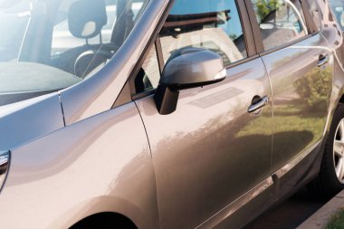 close-up view of shiny grey car parked on parking lot clipart