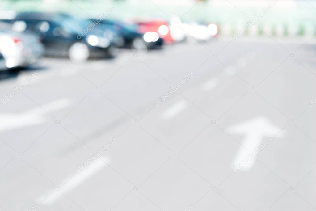 blurred background with cars parked on parking lot