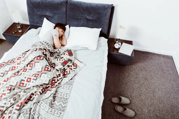 自宅のベッドで寝ている若い男のハイアングル — ストック写真