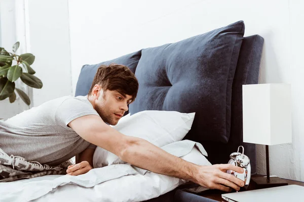 Selective Focus Young Man Turning Alarm Clock Bed Home — Stock Photo, Image