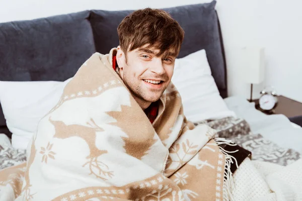 Laughing Young Man Wrapped Blanket Sitting Bed Home — Stock Photo, Image