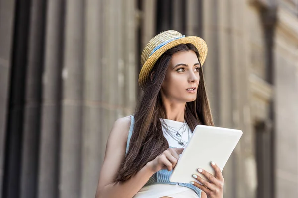 Portrait of young pretty woman with digital tablet on street — Stock Photo