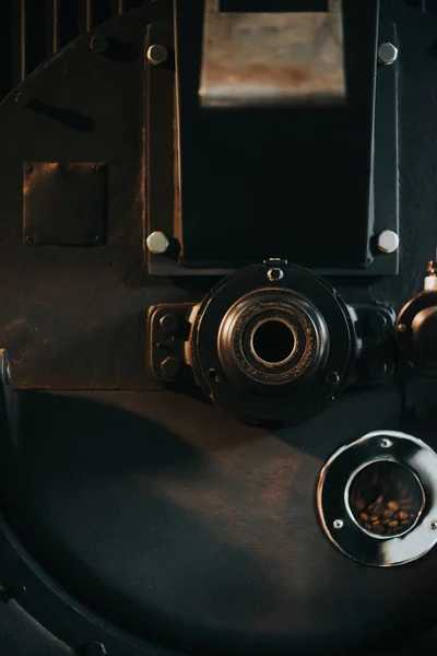 Hot coffee beans in traditional coffee roaster — Stock Photo