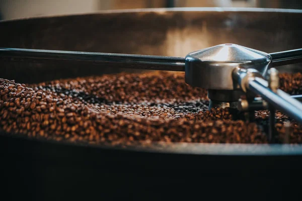 Coffee roaster cylinder roasting and mixing coffee beans — Stock Photo