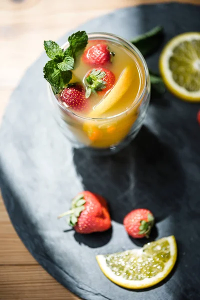 High angle view of fresh refreshing summer drink with mint and fruits on slate board — Stock Photo