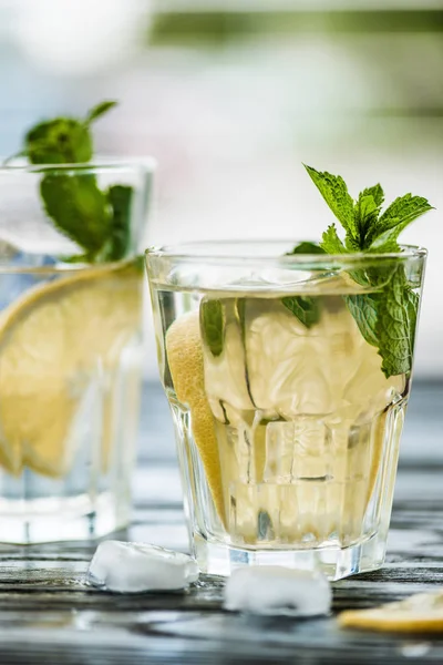 Close-up view of two glasses with fresh cold mojito cocktail on table — Stock Photo