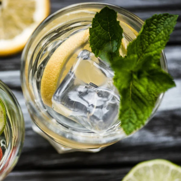 Draufsicht auf Cocktail mit Zitrone, Eiswürfeln und Minze im Glas — Stockfoto