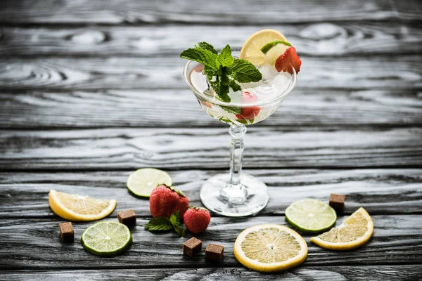 Delicious strawberry mojito cocktail in glass on wooden table — Stock Photo