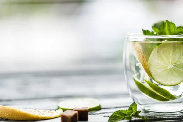 Close-up view of glass with fresh cold mojito cocktail on table — Stock Photo