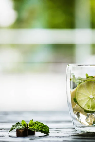 Glass of cold fresh cocktail with lime, mint and sugar — Stock Photo