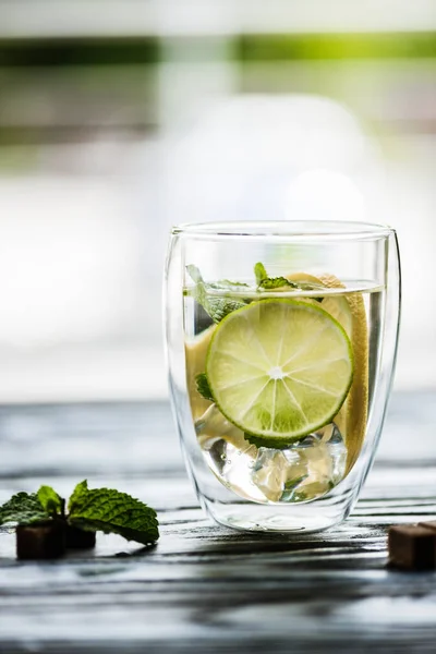 Glass of cold fresh mojito with lime, mint and sugar — Stock Photo