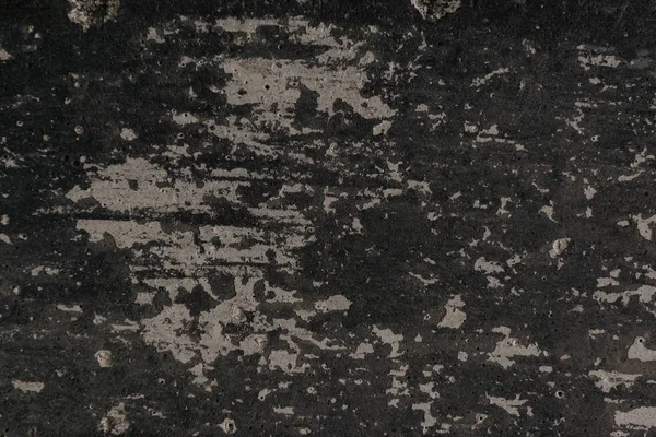 Текстура старой черной выветриваемой гранж-стены — стоковое фото