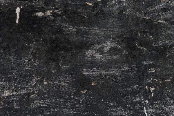 Old black weathered cement wall texture — Stock Photo