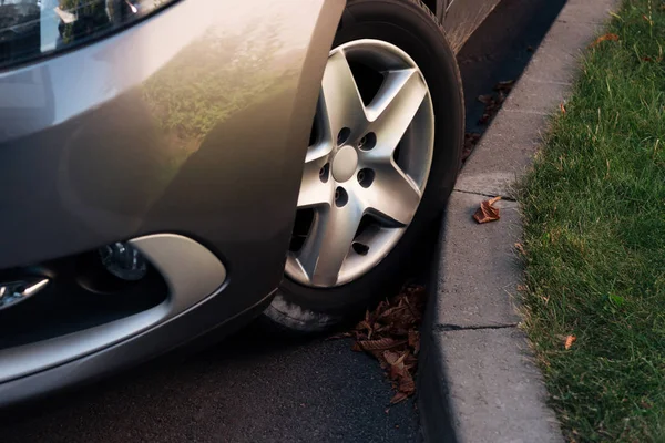 Detail of grey shiny car on parking lot and green grass — Stock Photo