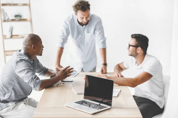 Multiethnic Businessmen Discussing New Business Idea Workplace Meeting Stock Photo