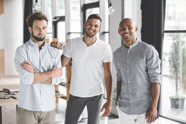 Multiethnic Young Businessmen Looking Camera While Standing Office Royalty Free Stock Images