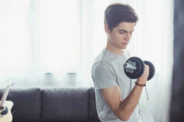 Serious Boy Training Dumbbell Home — Stock Photo, Image