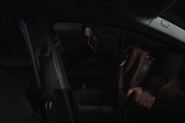 siyah hoodie araba çantasından hırsızlık dikkatli erkek hırsız