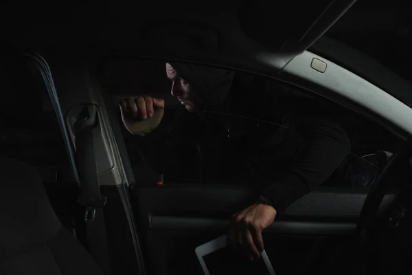 Male Thief Black Hoodie Stealing Digital Tablet Car — Free Stock Photo