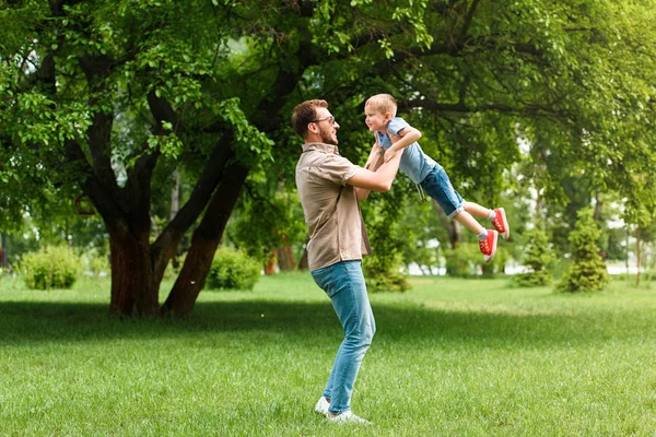 Side View Father Spinning Son Having Fun Park — Stock Photo, Image