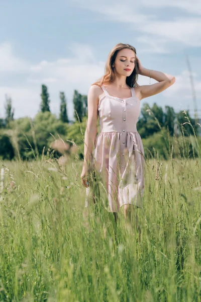 Young Pensive Woman Stylish Dress Long Hair Walking Meadow Alone — Free Stock Photo