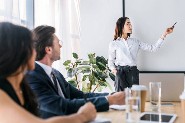 selective focus of multiracial businessman and businesswomen working on business project together in office