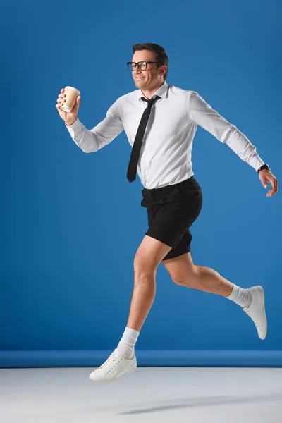 Happy Man Holding Disposable Coffee Cup While Jumping Looking Away — Stock Photo, Image