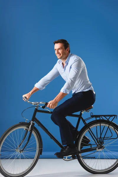 Smiling Businessman Riding Bicycle Looking Away Blue — Free Stock Photo