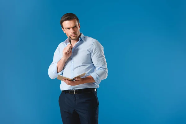 Thoughtful Businessman Holding Notepad Pen Isolated Blue — Stock Photo, Image