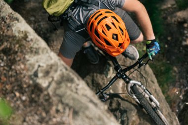 elevated view of male extreme cyclist in helmet riding on mountain bicycle  clipart