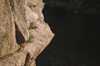 selective focus of rocky cliff over river  clipart