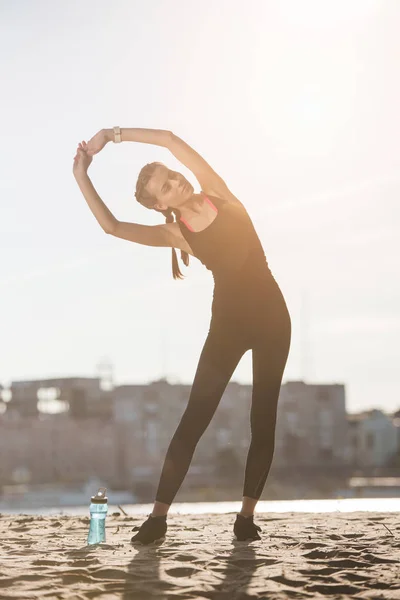 Attraktive Sportlerin Dehnt Sich Strand Mit Sportflasche — Stockfoto