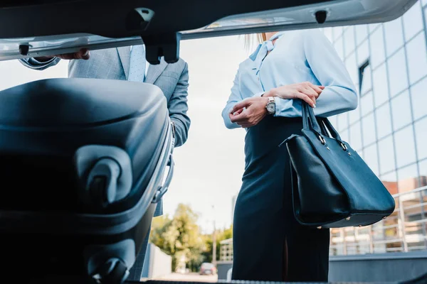 Partial View Businessman Putting Baggage Car Colleague — Stock Photo, Image