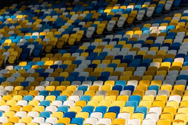 empty colorful seats on tribunes of stadium clipart