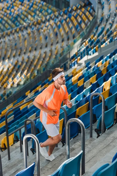 Sportive Young Man Jogging Upstairs Sports Stadium — Stock Photo, Image