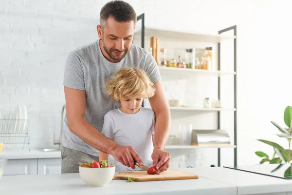 Father Cutting Strawberry Knife While His Son Standing Kitchen — Stock Photo, Image