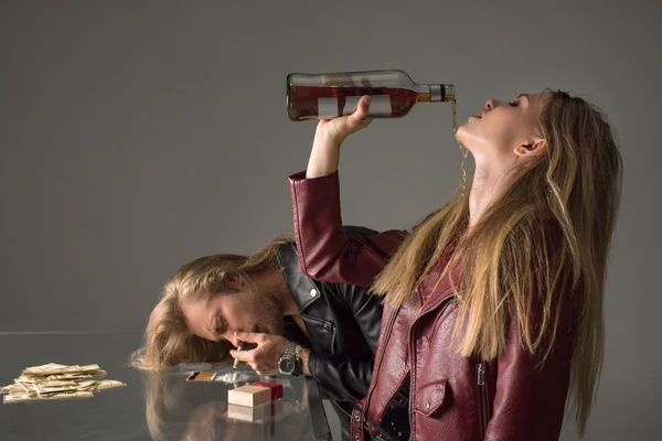 Junges Süchtiges Paar Trinkt Alkohol Und Schnuppert Kokain Auf Grau — Stockfoto