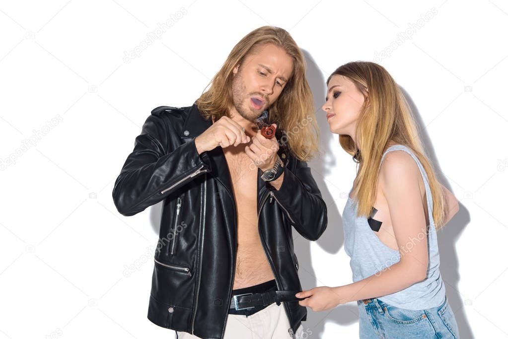 young addicted couple with pipe smoking cannabis on white
