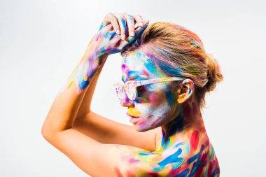 side view of attractive girl with colorful bright body art and sunglasses isolated on white clipart