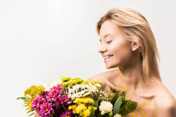 Happy Attractive Woman Yellow Paint Body Looking Bouquet Flowers Isolated — Free Stock Photo
