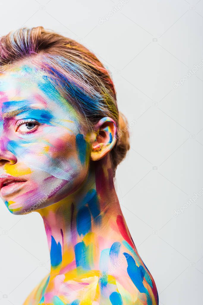 cropped image of attractive girl with colorful bright body art looking at camera isolated on white 