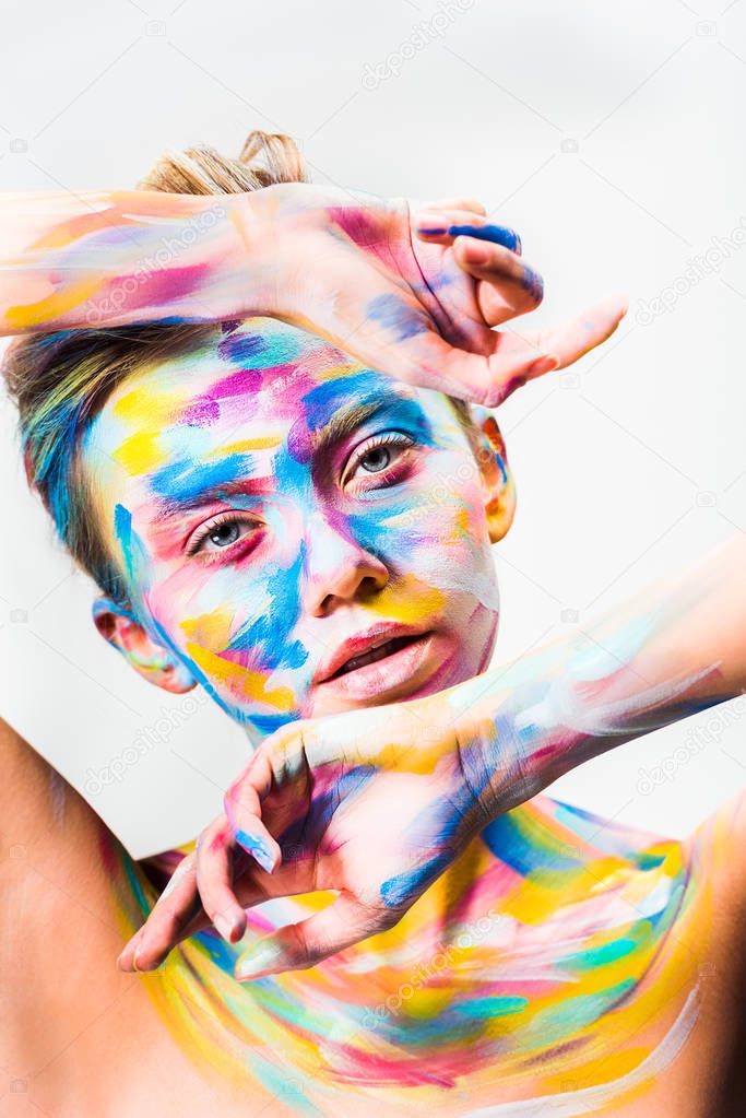 beautiful girl with colorful bright body art looking at camera isolated on white 