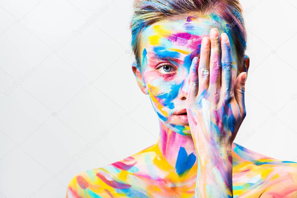 attractive girl with colorful bright body art covering eye isolated on white 