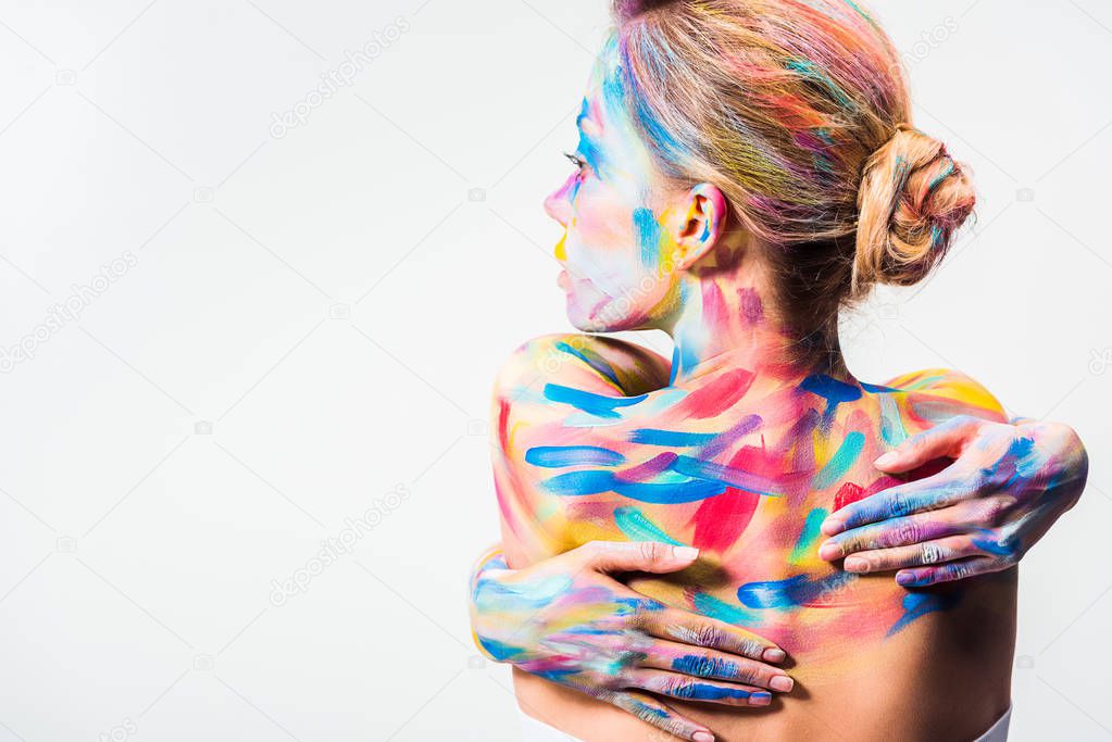 back view of attractive girl with colorful bright body art touching back isolated on white  