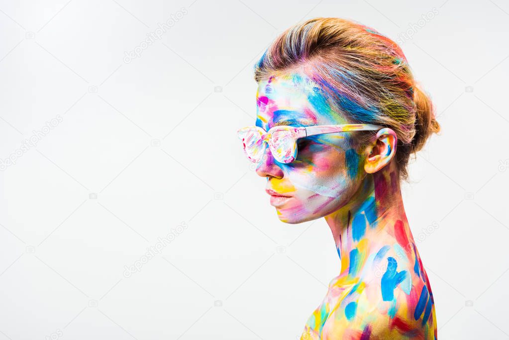 side view of attractive girl with colorful bright body art and sunglasses isolated on white