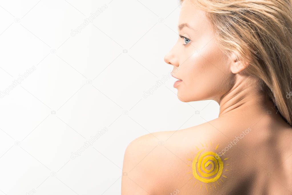 beautiful girl with painted yellow sun on shoulder looking away isolated on white